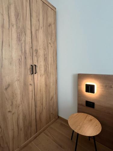 a room with a wooden cabinet and a wooden stool at YUGOGO PETRARCA 1 - Trilocale con balcone in Trento