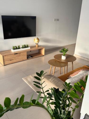 a living room with a flat screen tv on a wall at The Fifth Penthouse - 3 Large Bedrooms in Il-Gżira