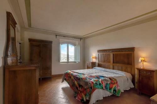 a bedroom with a bed and a window at Universal Harmony - Pettirosso in Dicomano