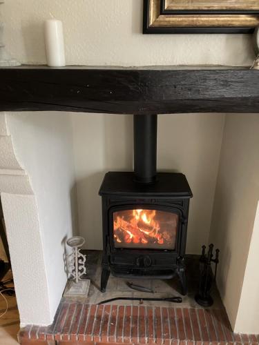 a stove in a room with a fireplace at Mountain View in Arcizans-Avant