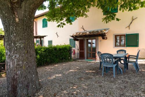 a table and chairs in front of a house at Universal Harmony - Cinciallegra in Dicomano