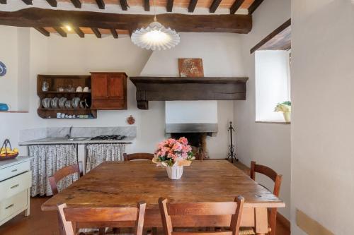 a dining room with a wooden table with flowers on it at Universal Harmony - Nibbio in Dicomano