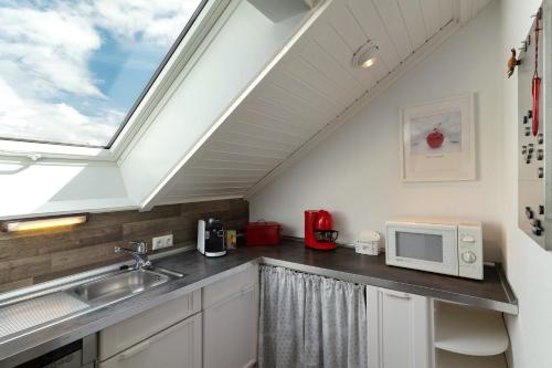a kitchen with a sink and a skylight at Ferienwohnung Sämann in Oberkirch