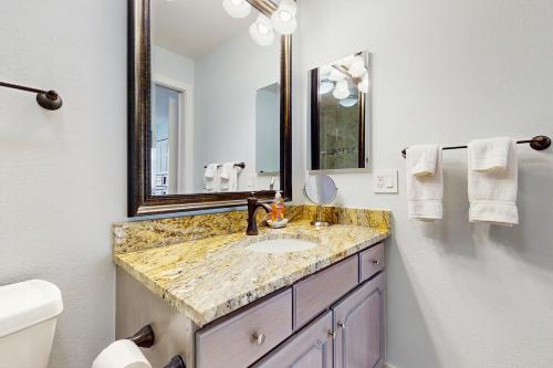 a bathroom with a sink and a mirror at Après Ski Hideaway, Unit 30A in Snowmass