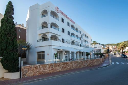 a white building on the side of a street at Pierre & Vacances Ros Ibiza in Santa Eularia des Riu