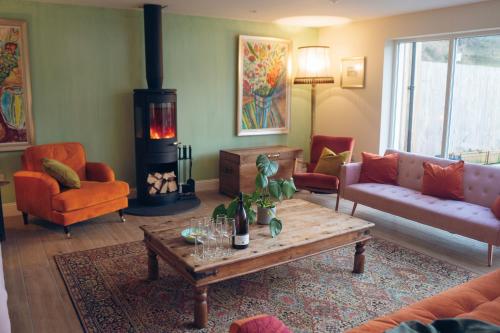 a living room with a couch and a table at Claggan Farmhouse, Loch Tay in Aberfeldy