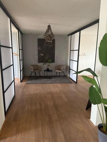 a living room with a table and chairs and a chandelier at Saya Loft in Amersfoort