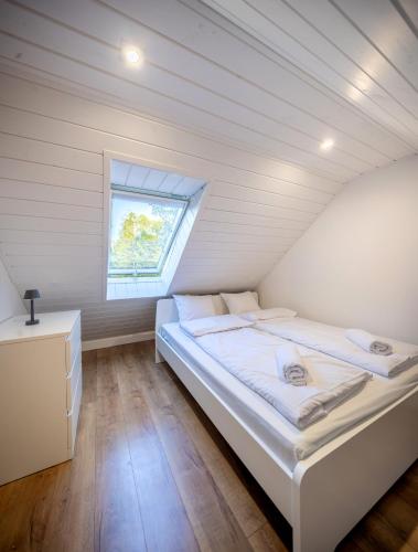 a small bedroom with a bed in a attic at Wilcza Stodoła 2 in Uście