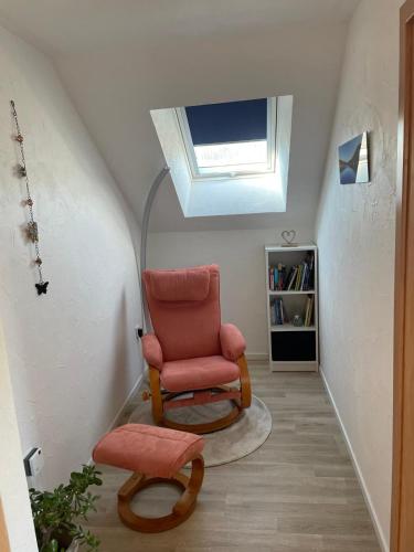 a living room with a chair and a skylight at Eifelbrise in Simmerath