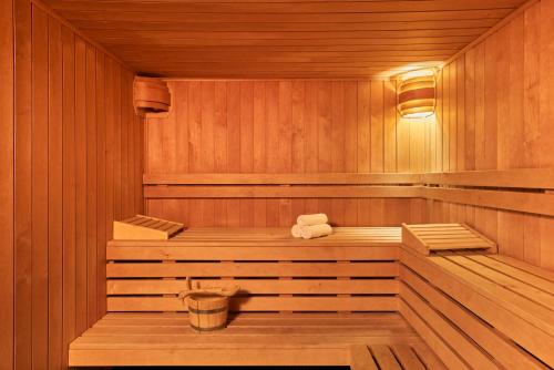 a wooden sauna with two towels in it at Hôtel Barrière Le Grand Hôtel Dinard in Dinard