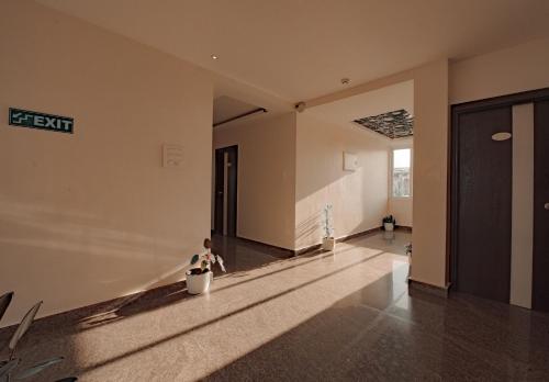 an empty room with a hallway with a sign on the wall at Hotel Horizon Hues in Port Blair