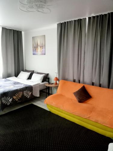 a bedroom with a bed and a couch in it at Family Home in Petropavlovsk