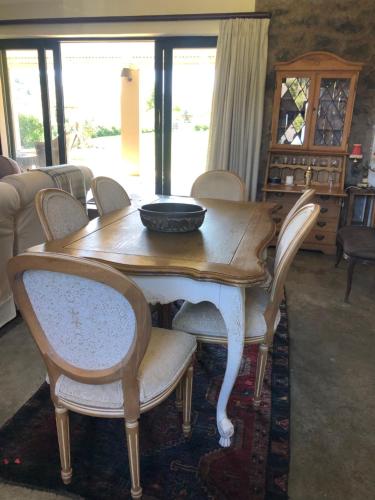 a wooden table with chairs and a bowl on top at Springvale Farm in Nottingham Road