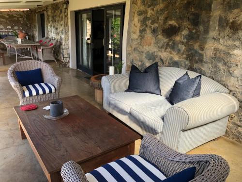 a living room with two chairs and a coffee table at Springvale Farm in Nottingham Road