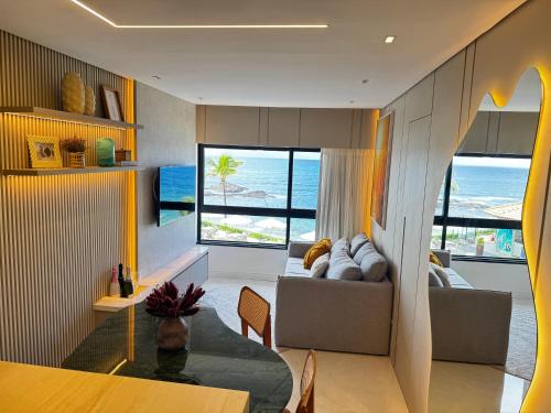 a living room with a view of the ocean at Ondina Apart Hotel Residences in Salvador