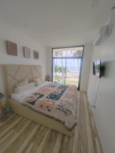 a bedroom with a bed with a view of the ocean at PRIVATE VILLA FRONT BEACH Infinity Pool in San Vicente