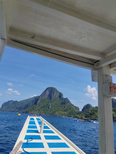 a boat on the water with mountains in the background at PRIVATE VILLA FRONT BEACH Infinity Pool in San Vicente