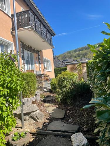 a house with a walkway in front of a building at Eifelbrise in Simmerath