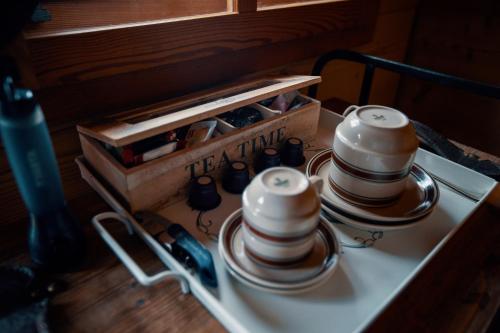 a group of cups and bowls on a table at Le Mayen de Colombire in Crans-Montana