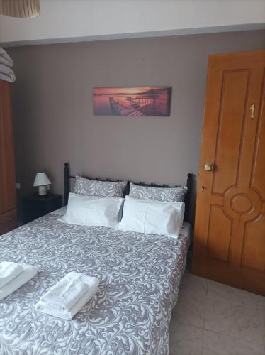 a bedroom with a bed with two towels on it at Eirini's Apartment in Missolonghi