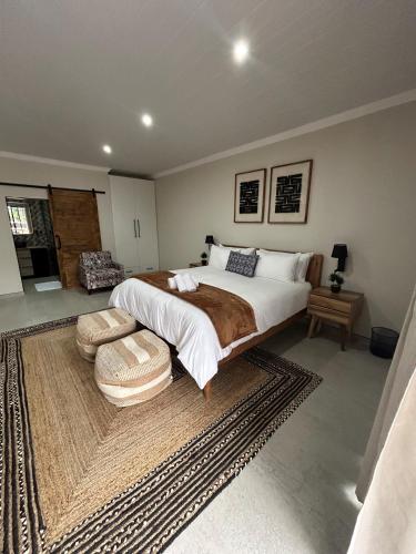 a bedroom with a large bed and a rug at The Sanctuary Guest House in East London