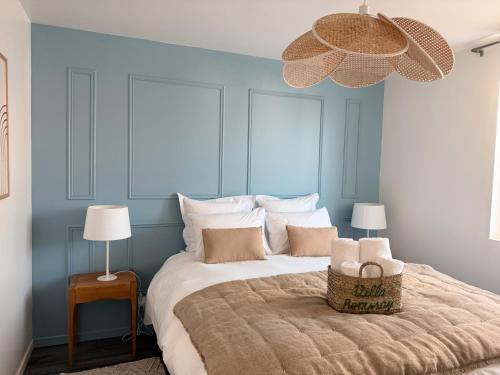 une chambre avec un grand lit avec un mur bleu dans l'établissement Villa Rompsay, à La Rochelle