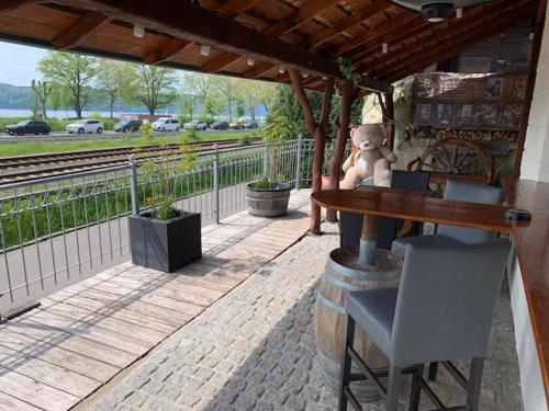 a teddy bear sitting at a table on a patio at Gästehaus zum Felsen in Überlingen