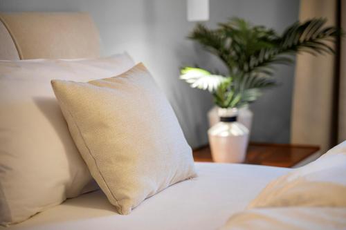 a pillow on a bed with a vase of flowers at Elegant in Aschaffenburg