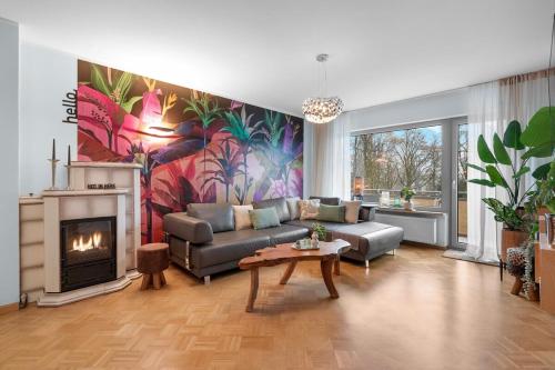 a living room with a couch and a fireplace at Elegant in Aschaffenburg