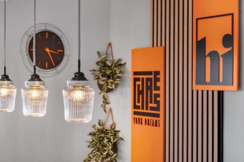 a wall with lights and a clock and a clock at Elegant in Aschaffenburg