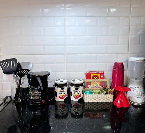 a kitchen counter top with a group of food items at Recanto de Itaipava - casa com forno de pizza a lenha, churrasqueira, pet friendly, equipada para até 6 pessoas, em meio à Natureza e próxima ao centro do bairro in Petrópolis