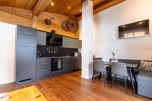 a kitchen and dining room with a table and chairs at Appartement Hoamatgfüh in Saalbach-Hinterglemm