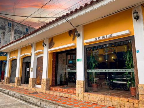 a store front of a building with windows at Hotel Casa Madrid in Puerto Berrío