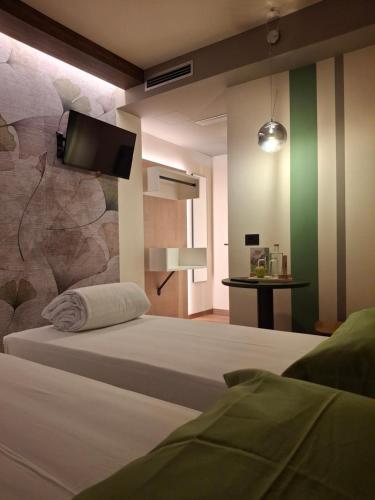 Postel nebo postele na pokoji v ubytování Hotel Dolomiti Saone