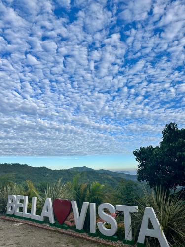 a sign that says bela usa on a mountain at Cabañas Bellavista La Vega in La Vega