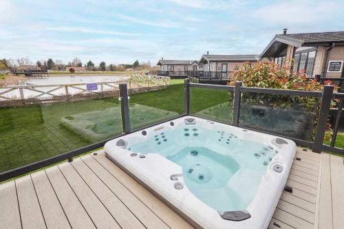 a jacuzzi tub sitting on top of a deck at Host & Stay - Roseberry View Lodge Retreat in Great Ayton