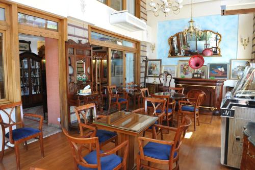 a restaurant with tables and chairs in a room at Hotel Katerina in Athens