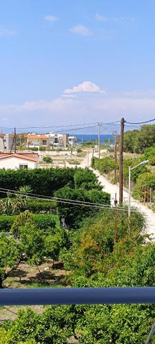 a view from a balcony of a street and a road at Pyrgos Hotel Apartments in Kremasti
