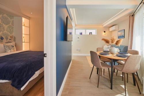 a bedroom and a dining room with a table and chairs at Apartment Ivan in Pomorie