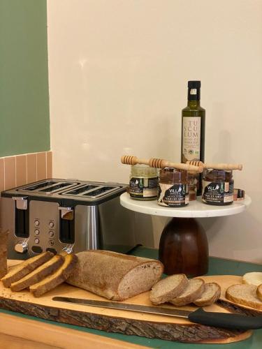 a shelf with bread and a bottle of wine on a counter at Villa Cavalletti Appartamenti in Grottaferrata