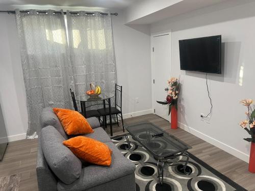a living room with a couch and a flat screen tv at Peaceful Haven in Saskatoon