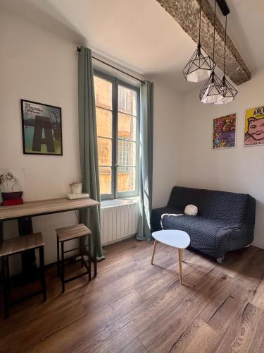 a living room with a couch and a table at Stud'Arles in Arles