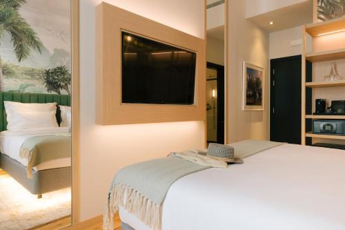 a bedroom with a bed and a television on the wall at Pestana Rua Augusta Lisboa in Lisbon