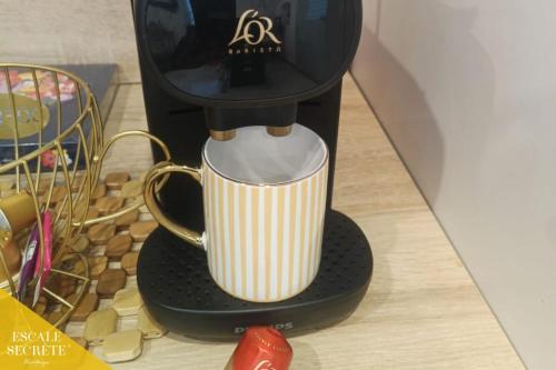 a coffee maker sitting on top of a counter at Escale secrète Montargis Jacuzzi Terrasse Parking gratuit in Montargis