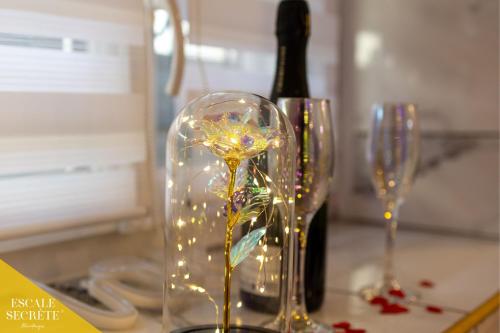 two wine glasses with lights in them on a counter at Escale secrète Montargis Jacuzzi Terrasse Parking gratuit in Montargis