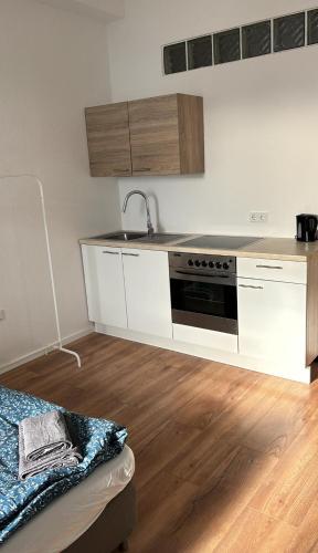 a kitchen with a sink and a stove at Modernes Apartment Dornberg in Bielefeld