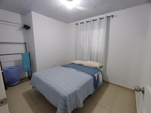 a bedroom with a bed in a white room at Tierras Altas Retreat in Volcán
