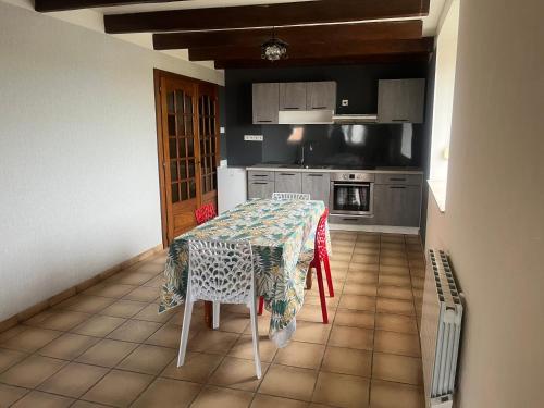 a kitchen with a table with a table cloth on it at Chez Mady in Kirschnaumen