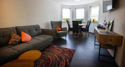 a living room with a couch and a table at Ferienwohnung Baßler in Kappelrodeck