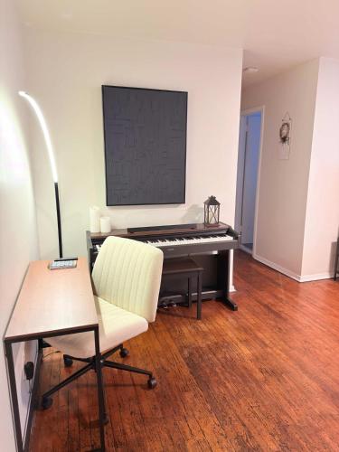 a living room with a piano and a chair at Independence Day Best Fireworks View July 6 in Clifton